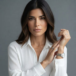 Camila Coelho wearing a white long-sleeved pleated casual shirt in a professional editorial portrait.